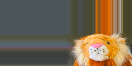 Lion doll on blurred background with copy space for your text. Tileable image.の写真素材