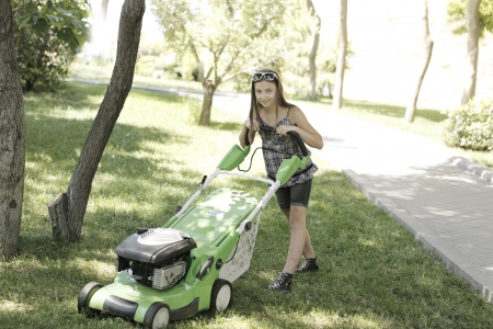 Girl with lawn mowerの写真素材