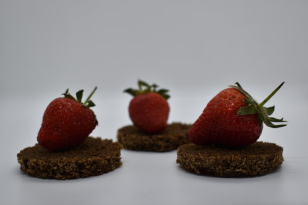 Strawberries on chocolate cookies on a white background. Close-up.の写真素材