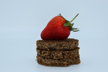 Strawberry on a stack of crispbread on a white background
