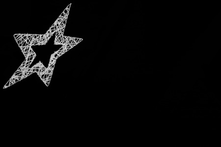 Silver star made from vires isolated on black backgroundの写真素材