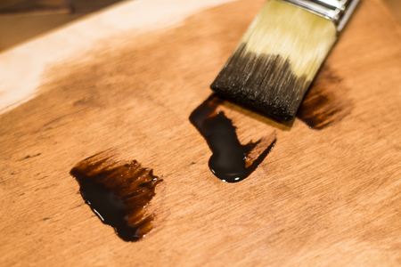 Large brushes and some parts of paint on the background of the old tree with small spots of paint.の写真素材