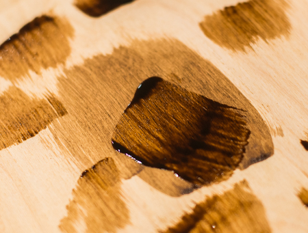 Large brushes and some parts of paint on the background of the old tree with small spots of paint.の写真素材