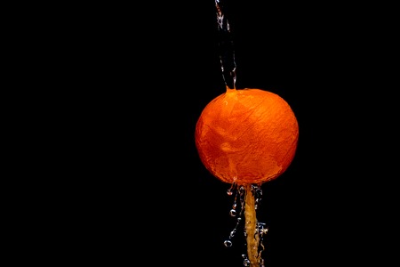 fruit falling in the water on a black backgroundの写真素材