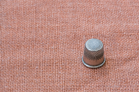 A metal thimble. Close-up, space for textの写真素材