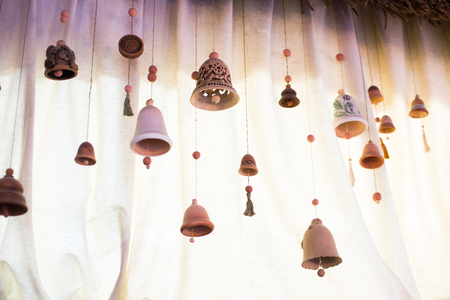 Original clay bells on a light background. Place for your textの写真素材