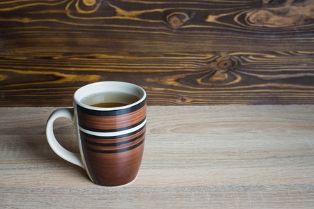 A glass of homemade lemonade on a wooden background.の写真素材
