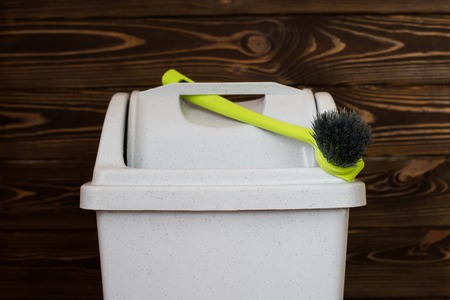 Trash can and brush. A close-up of a bin and brushes.の写真素材