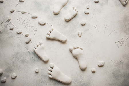 Decorative wall in the form of feet. Human footprints in stone.の写真素材