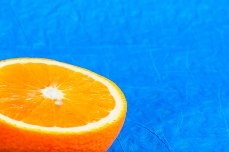 Orange isolated on blue background. Complementary colorsの写真素材