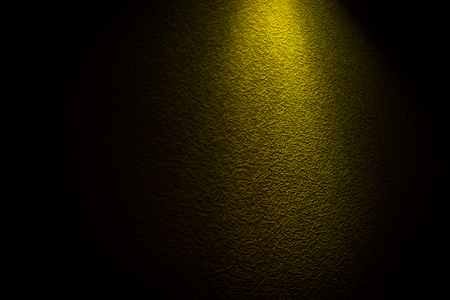 reflection of yellow light on a black wallの写真素材