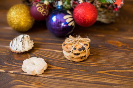 Christmas gingerbread cookies on a wooden table decorated with a garland on a wooden background, top...