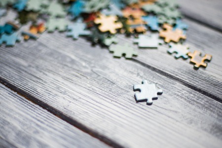 Puzzles on a light wooden backgroundの写真素材