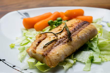 Salmon fillets served on a plate with mixed saladの写真素材