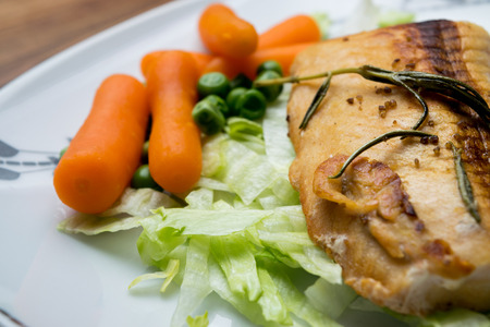 Salmon fillets served on a plate with mixed saladの写真素材
