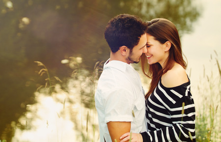 happy romantic sensual couple in love together outdoors on summer vacationの写真素材