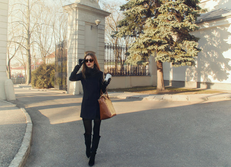 young beautiful woman with coffee outdoor in the cityの写真素材