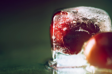 frozen delicious red cherry in ice backgroundの写真素材