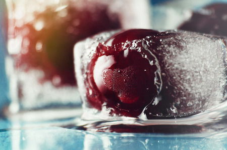 frozen delicious red cherry in ice backgroundの写真素材
