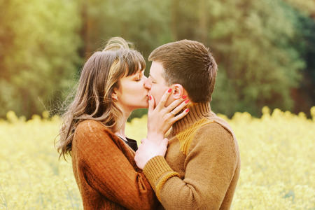 young sensual happy couple kissing in love outdoor into the depth of beautiful nature の写真素材