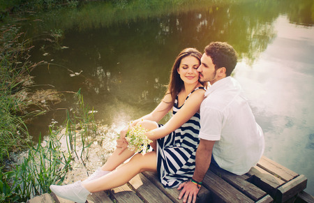 sensual romantic couple in love on pier at the lake outdoor in summer day, beauty of nature, harmony conceptの写真素材