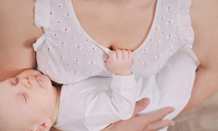 mother and her newborn baby, maternity concept, soft image of beautiful familyの写真素材