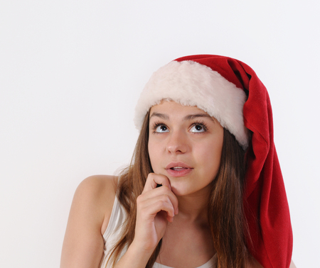 portrait of beautful girl in Santa hat dreaming about Christmas holiday.の写真素材