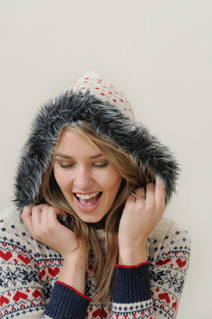 beauty face portrait of attractive smiling woman in warm clothing.の写真素材
