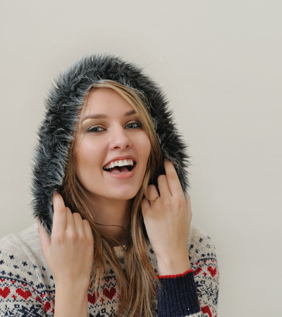 beauty face portrait of attractive young caucasian woman in warm clothing. studio shotの写真素材