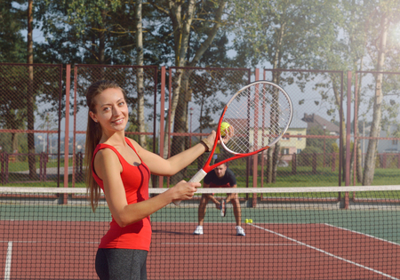 Woman playing tennis and preparing for sports competition. Women against men.Healthy fitness concept with active lifestyle.の写真素材