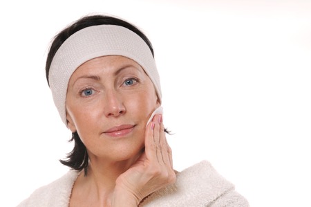 portrait of pretty senior woman taking off makeupの写真素材