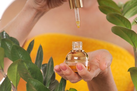 close up shoot of womans hands with essential oilの写真素材