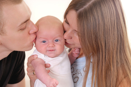 Closeup portrait of beautiful young family with newbornの写真素材