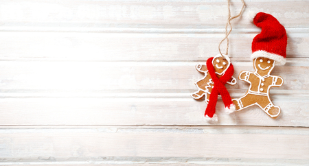Flat lay xmas gingerbread man on wooden boards. Christmas homemade gingerbread cookies over wooden backgroundの写真素材