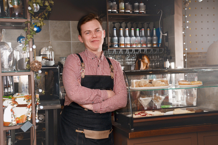 Barista man at workplace in coffee shop cafe. Food and drink industry conceptの写真素材
