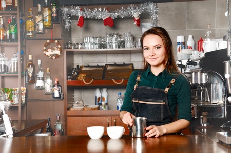 Barista woman at workplace in coffee shop cafe. Food and drink industry conceptの写真素材