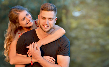 Happy young couple hugging and laughing outdoors. Happy couple spending time in the parkの写真素材