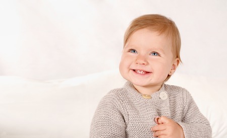 Portrait of a little smiling girl at home. Close up portrait. Happy childhood conceptの写真素材