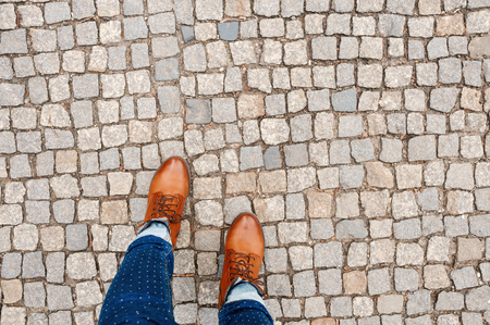 Brown shoes on the stone pavement. View from aboveの写真素材