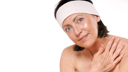 Spa portrait of attractive smiling mature woman. Isolated on white. Studio shotの写真素材