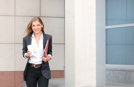 Beautiful businesswoman on the phone at modern building. City business woman workingの写真素材