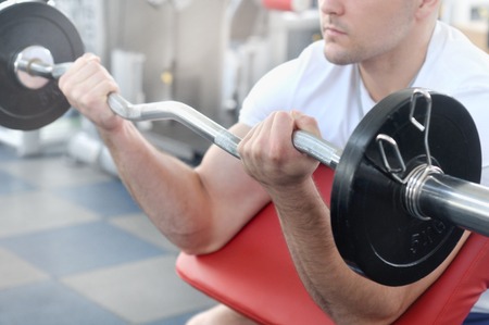 Very power athletic man bodybuilder do execute exercise with barbell. Fitness conceptの写真素材