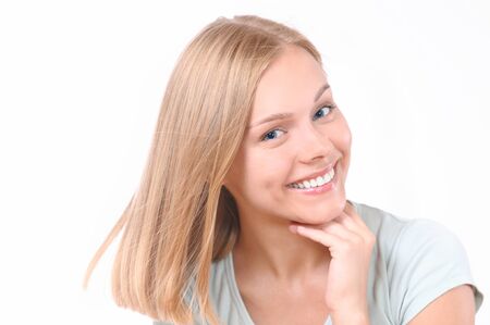 Beautiful woman touching her face. Perfect fresh skin. Pure beauty model girl. Youth and skin care conceptの写真素材