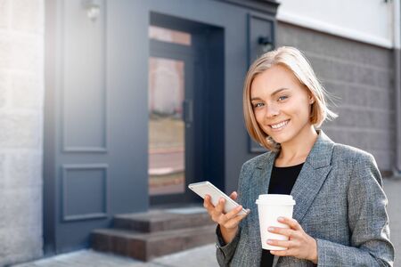 Business girl on a coffee break. Office woman on the phone while on breakの写真素材