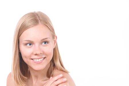 Pretty smiling joyfully female with blonde hair. Studio shot of good-looking beautiful woman isolated against blank studio wallの写真素材