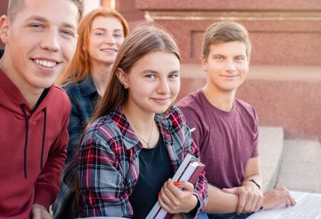 Happy smiling group of students studying outdoors near university. Education conceptの写真素材