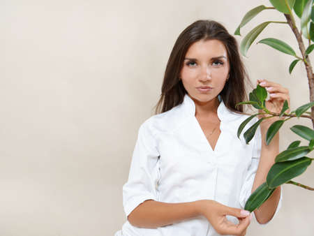 Portrait of beautiful brunette woman with healthy natural glowing skin. Healthy beauty concept.の写真素材