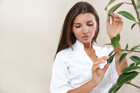 Portrait of beautiful brunette woman with healthy natural glowing skin. Healthy beauty concept.の写真素材