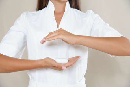 Close up photo of woman's hands in circle with tablets in a white robe. Healthy eating concept.の写真素材