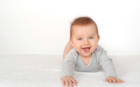 Portrait of a cute baby boy with blue eyes on white background. Healthy childhood innocence concept.の写真素材